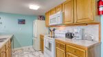 Fully equipped kitchen with dishwasher, microwave, and coffee maker 